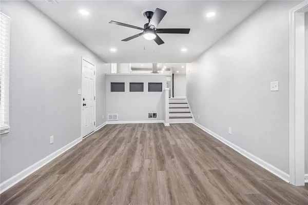 wooden floor in an empty room with a window
