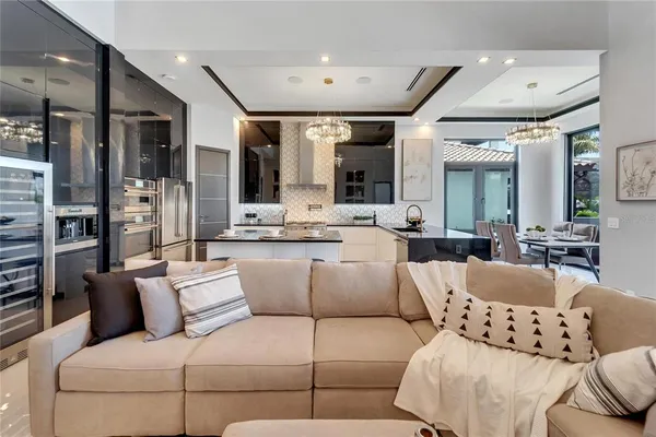 a bedroom with a bed a couch and a chandelier