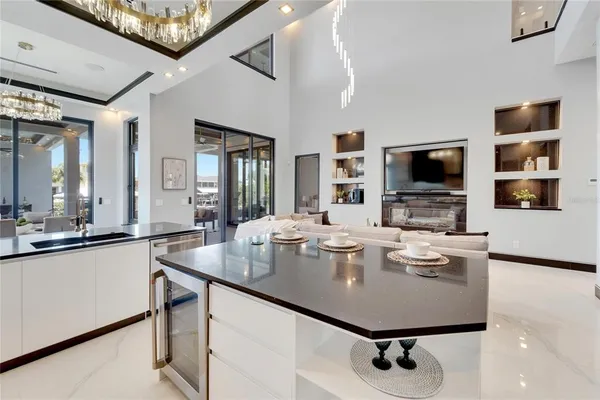 a bedroom with a bed and a potted plant on the dresser