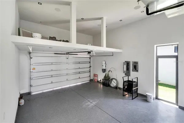 a view of hallway with furniture and floor to ceiling window