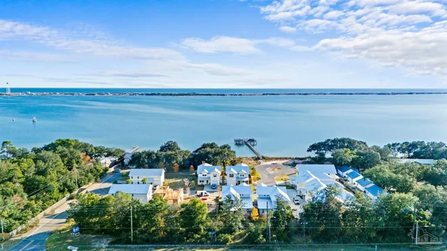 an aerial view of house with yard and ocean view