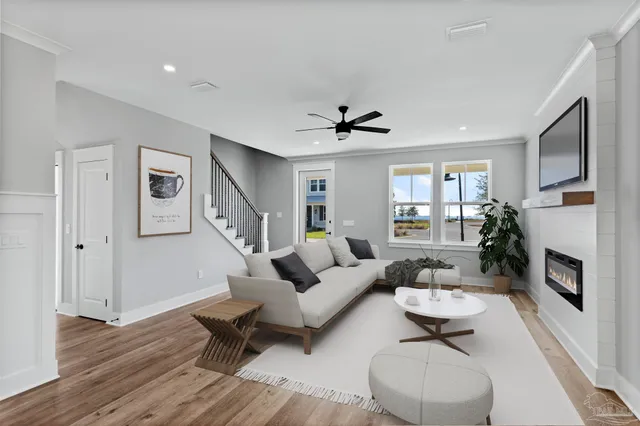 a living room with furniture and a wooden floor