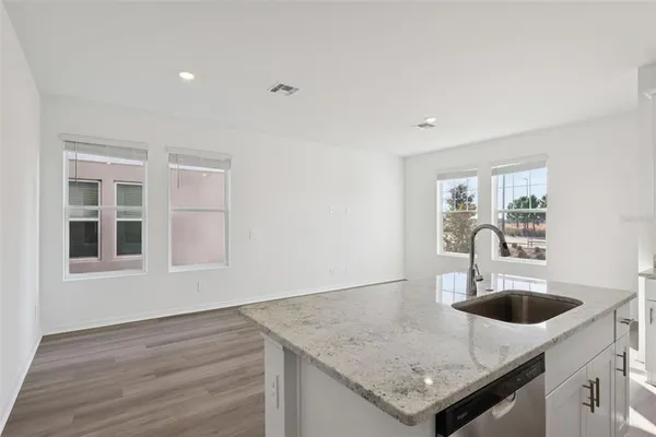 a kitchen with granite countertop a sink and a window