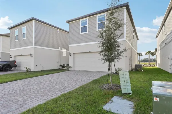 a backyard of a house with plants and a patio