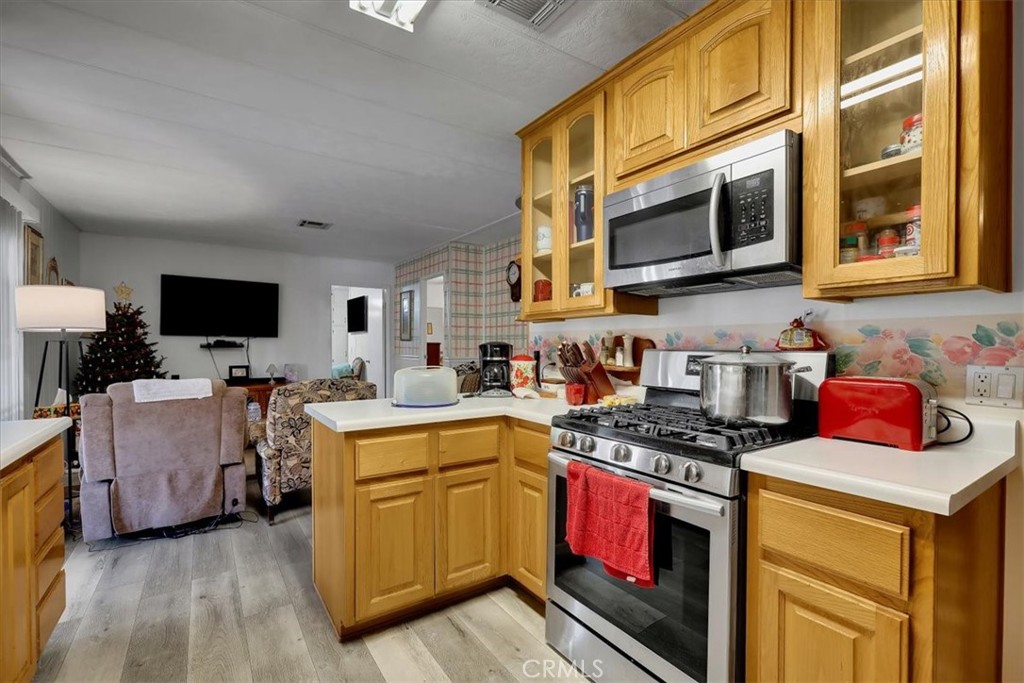 9800 Base Line Road, Unit 114 Rancho Cucamonga, CA 91701 - Photo 11 of 48 a kitchen with stainless steel appliances granite countertop a stove and a microwave