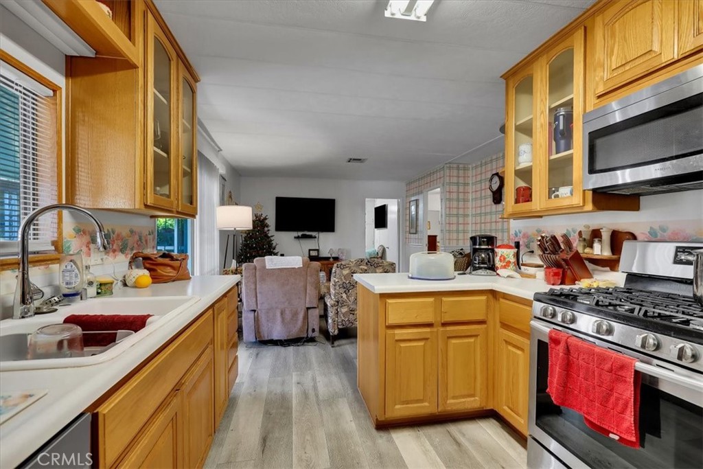9800 Base Line Road, Unit 114 Rancho Cucamonga, CA 91701 - Photo 12 of 48 a kitchen that has a sink and a stove top oven