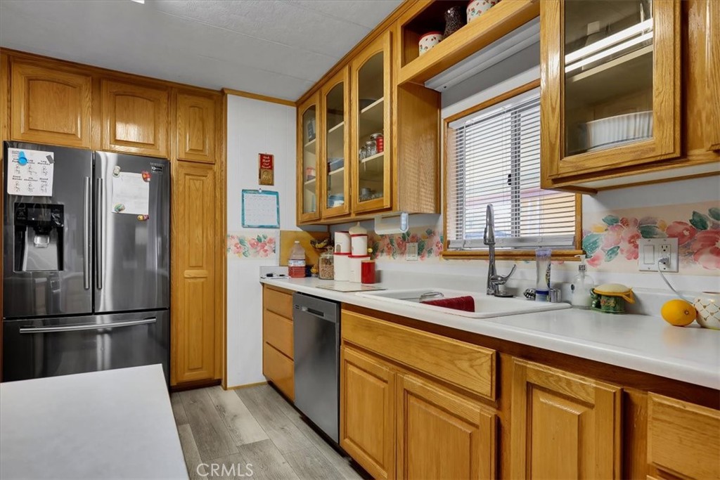 9800 Base Line Road, Unit 114 Rancho Cucamonga, CA 91701 - Photo 13 of 48 a kitchen with stainless steel appliances a sink and a refrigerator