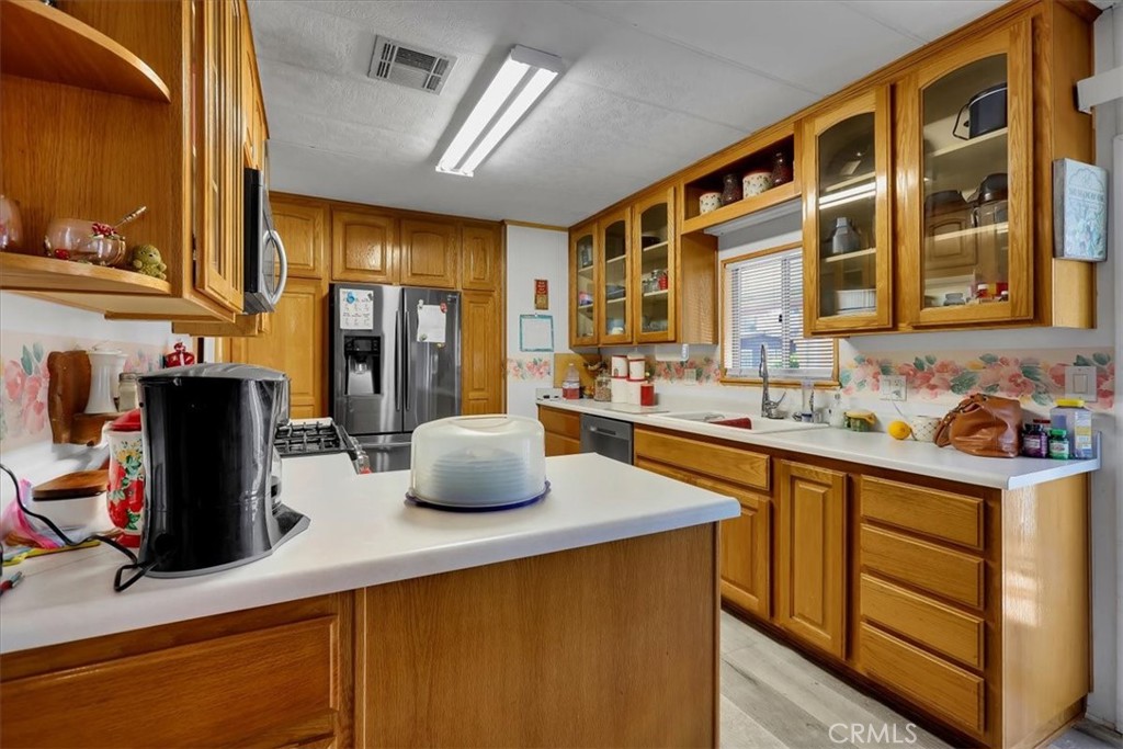 9800 Base Line Road, Unit 114 Rancho Cucamonga, CA 91701 - Photo 14 of 48 a kitchen with stainless steel appliances a sink stove and refrigerator