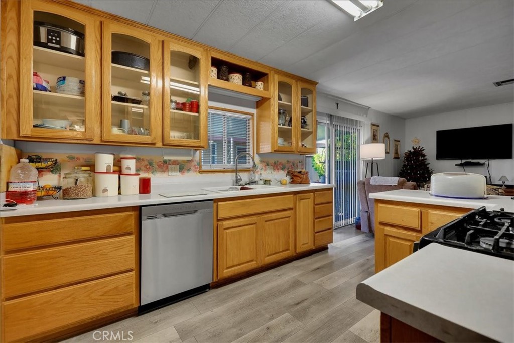 9800 Base Line Road, Unit 114 Rancho Cucamonga, CA 91701 - Photo 17 of 48 a kitchen with stainless steel appliances kitchen island granite countertop a sink and cabinets