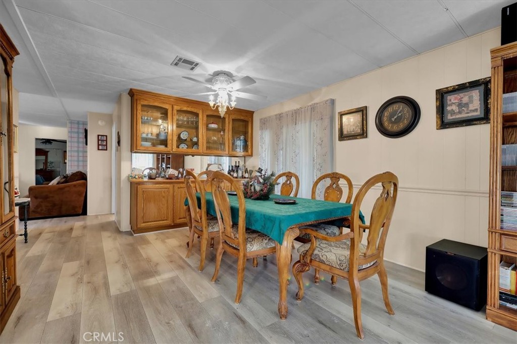 9800 Base Line Road, Unit 114 Rancho Cucamonga, CA 91701 - Photo 20 of 48 a view of a dining room with furniture and wooden floor