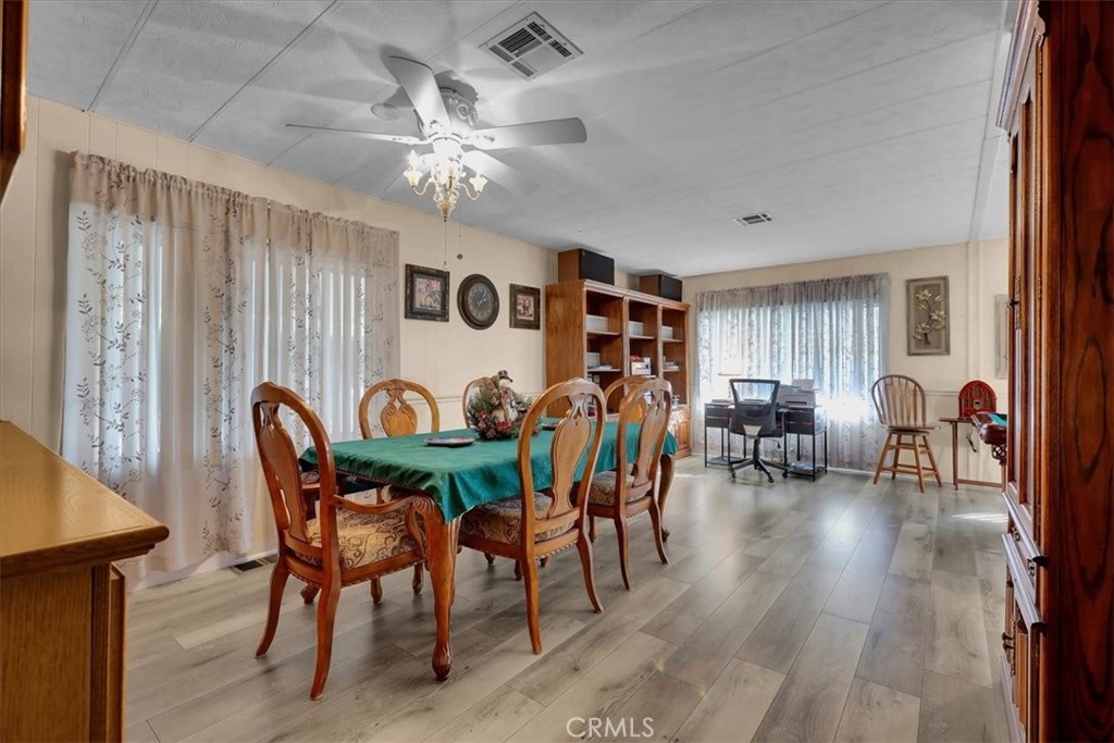 9800 Base Line Road, Unit 114 Rancho Cucamonga, CA 91701 - Photo 21 of 48 a view of a dining room with furniture and wooden floor