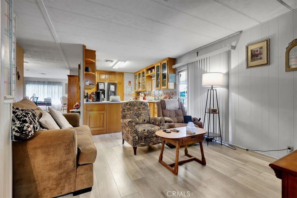 9800 Base Line Road, Unit 114 Rancho Cucamonga, CA 91701 - Photo 25 of 48 a living room with furniture and a wooden floor