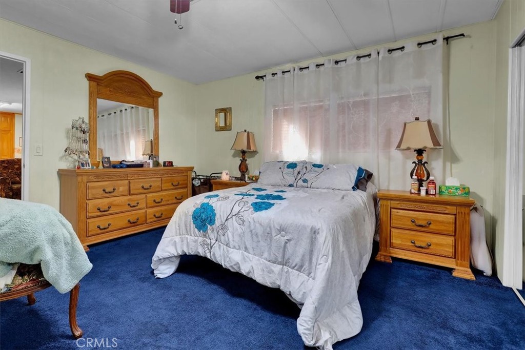 9800 Base Line Road, Unit 114 Rancho Cucamonga, CA 91701 - Photo 29 of 48 a bedroom with a bed and a dresser