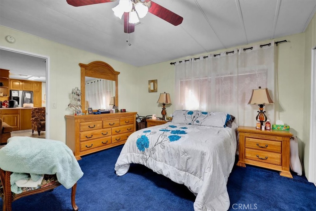 9800 Base Line Road, Unit 114 Rancho Cucamonga, CA 91701 - Photo 30 of 48 a bed room with bed and a chandelier