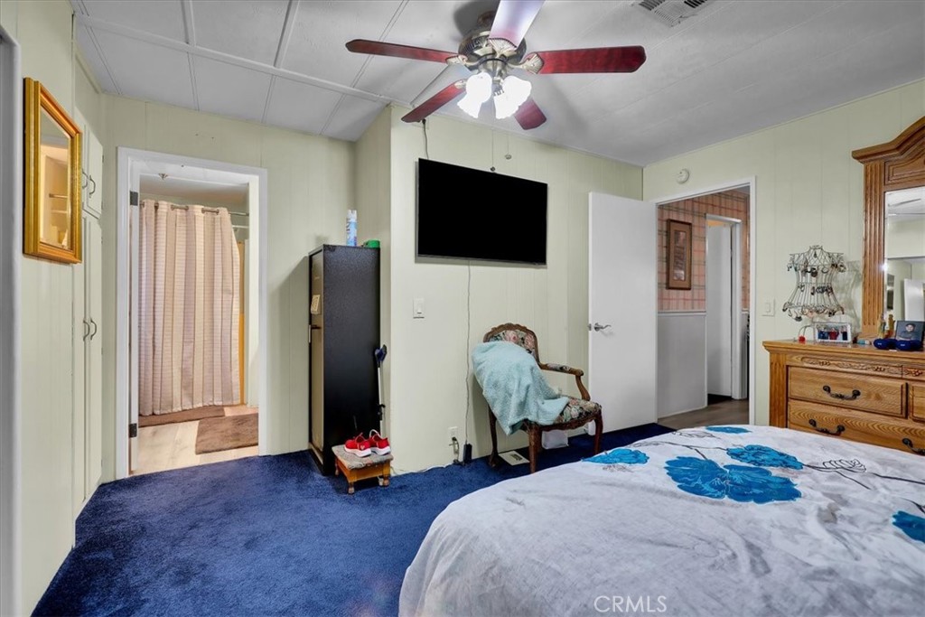 9800 Base Line Road, Unit 114 Rancho Cucamonga, CA 91701 - Photo 31 of 48 a bedroom with a bed and a chandelier