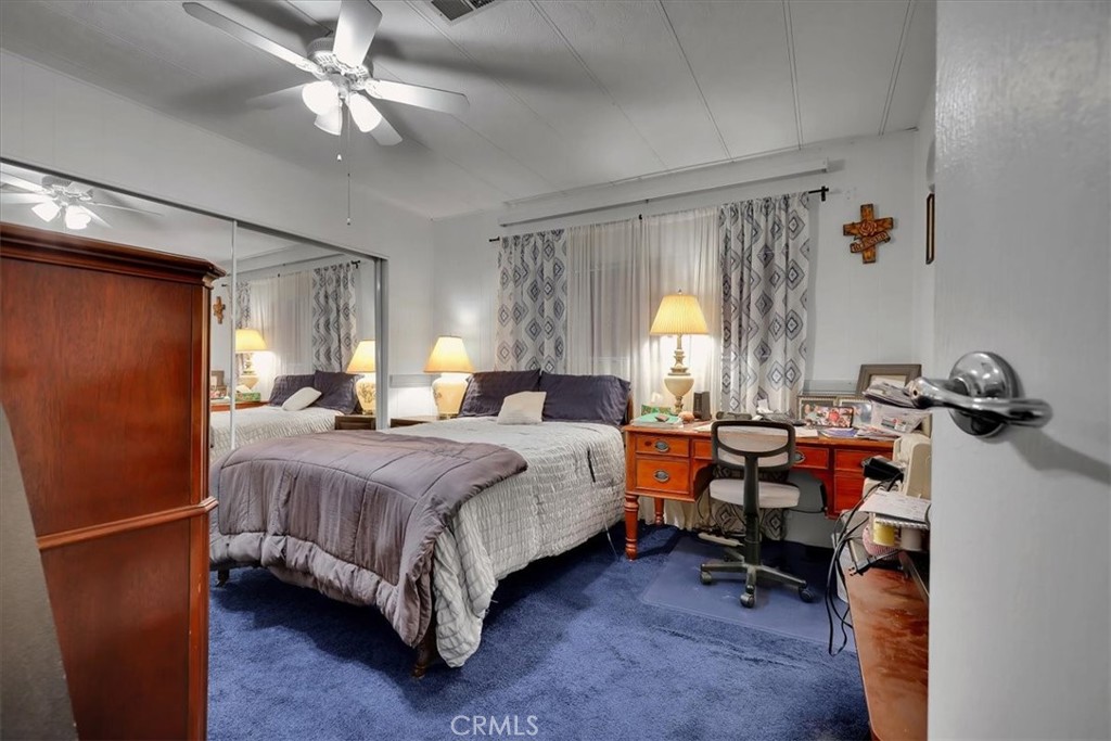 9800 Base Line Road, Unit 114 Rancho Cucamonga, CA 91701 - Photo 34 of 48 a spacious bedroom with a bed and a chandelier