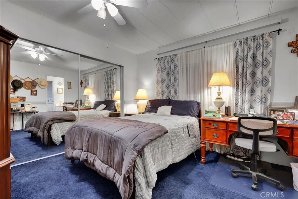 9800 Base Line Road, Unit 114 Rancho Cucamonga, CA 91701 - Photo 35 of 48 a spacious bedroom with a bed and a chandelier