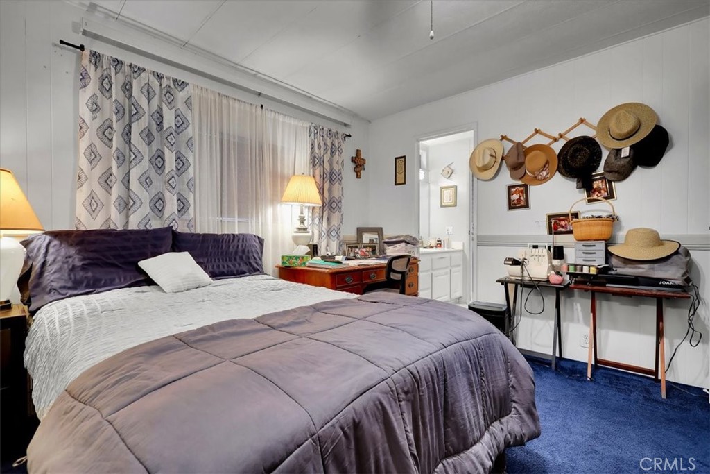 9800 Base Line Road, Unit 114 Rancho Cucamonga, CA 91701 - Photo 37 of 48 a bedroom with a bed and wooden floor