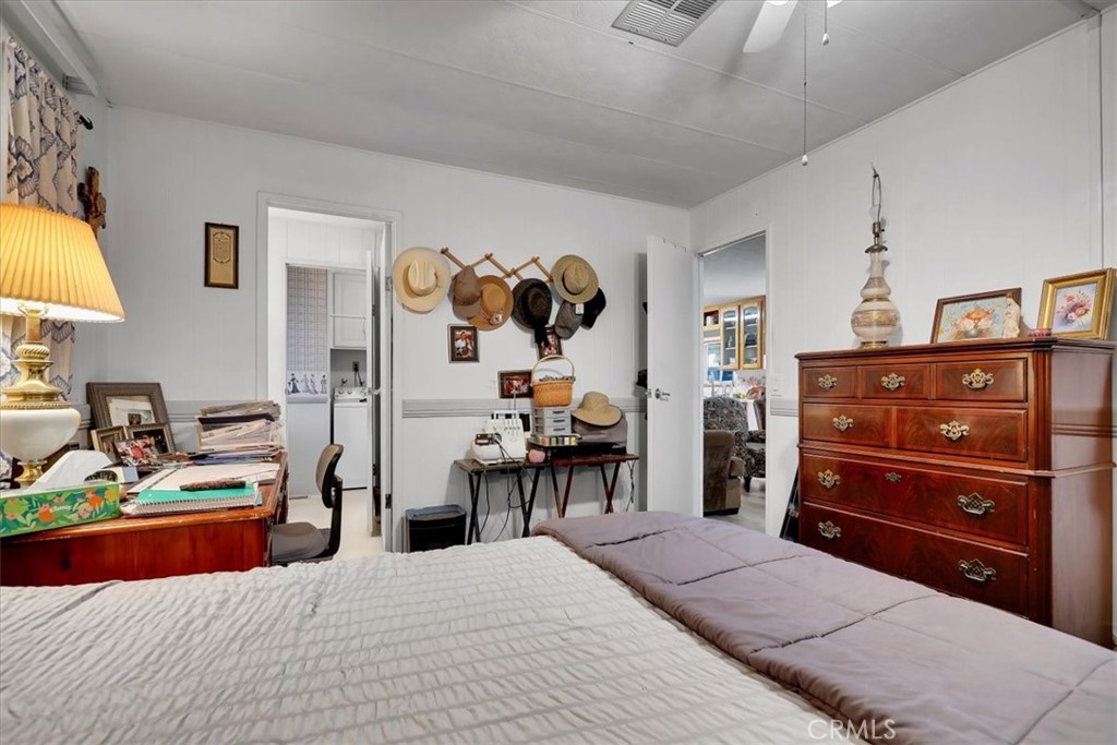 9800 Base Line Road, Unit 114 Rancho Cucamonga, CA 91701 - Photo 38 of 48 a bedroom with a bed and a chandelier