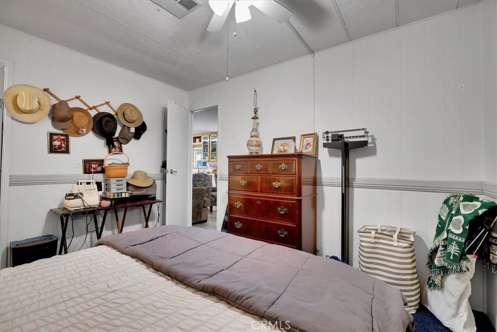 9800 Base Line Road, Unit 114 Rancho Cucamonga, CA 91701 - Photo 39 of 48 a bedroom with a bed and a chandelier