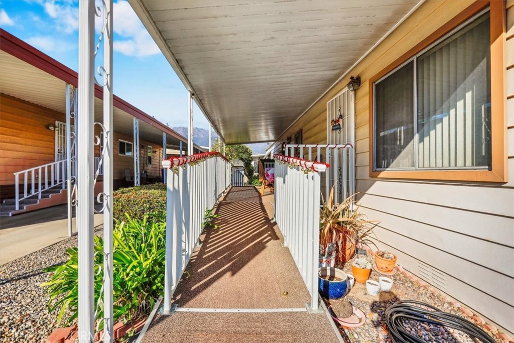 9800 Base Line Road, Unit 114 Rancho Cucamonga, CA 91701 - Photo 5 of 48 a view of a balcony with wooden floor and stairs