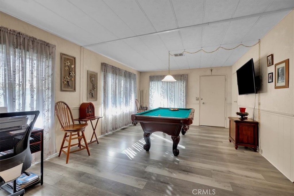 9800 Base Line Road, Unit 114 Rancho Cucamonga, CA 91701 - Photo 8 of 48 a living room with furniture a dining table and chairs with wooden floor