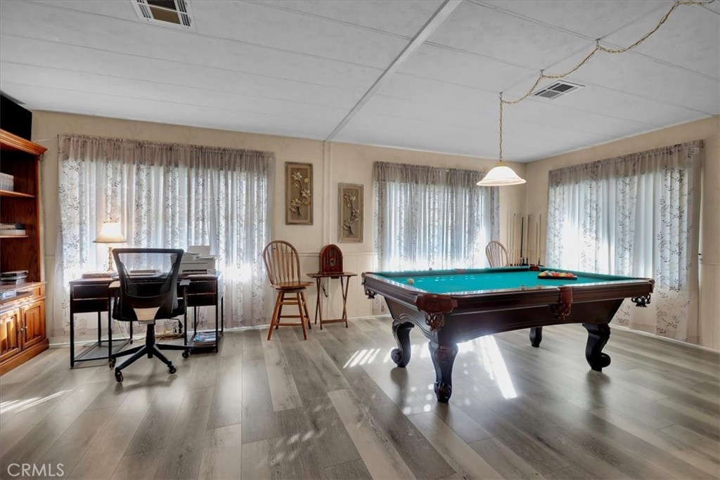 9800 Base Line Road, Unit 114 Rancho Cucamonga, CA 91701 - Photo 9 of 48 a room with furniture pool table wooden floor and windows