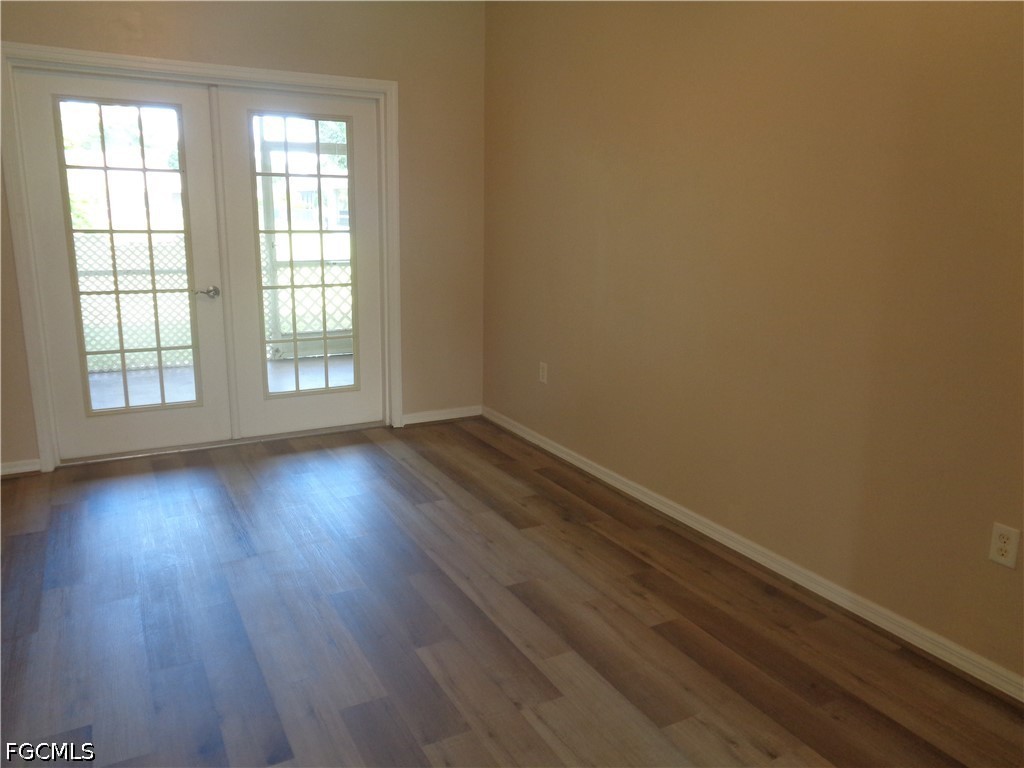 2463 Nature Pointe Loop Fort Myers, FL 33905 - Photo 19 of 50 an empty room with wooden floor and windows