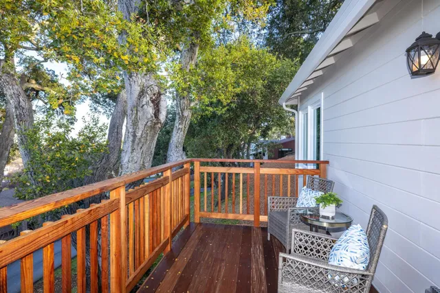 a kitchen with stainless steel appliances kitchen island granite countertop a sink a stove and refrigerator