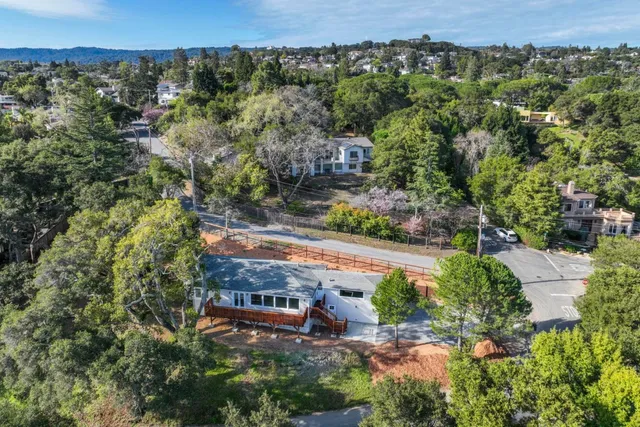 an aerial view of a house with a yard