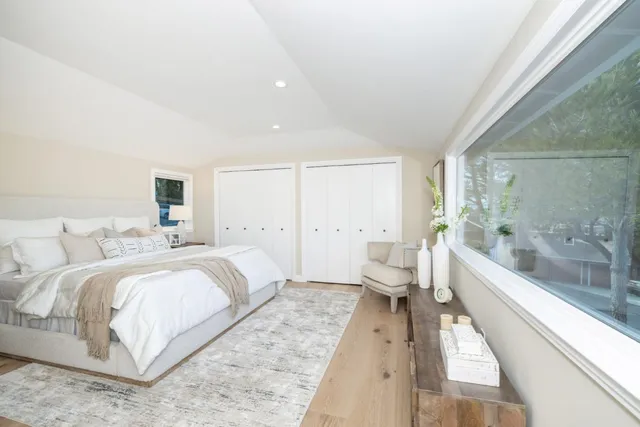 a bedroom with a large bed and a couch