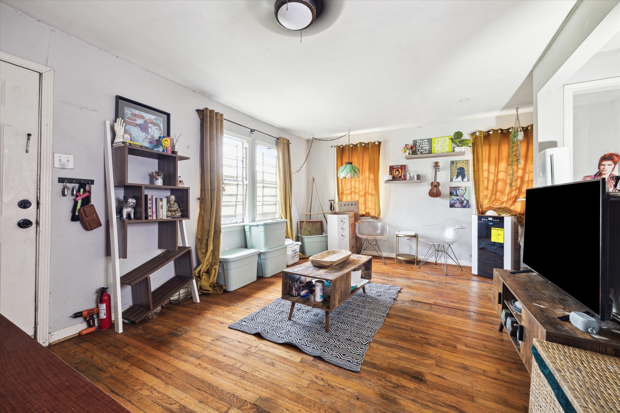 1206 Shearn Street Houston, TX 77007 - Photo 2 of 11 Living room features hardwood flooring, large window for natural light, and a pass-through to the kitchen