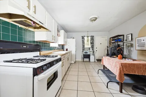 a kitchen with a stove and a refrigerator