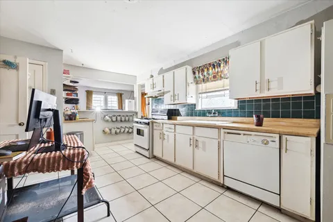 a kitchen with a sink cabinets and window