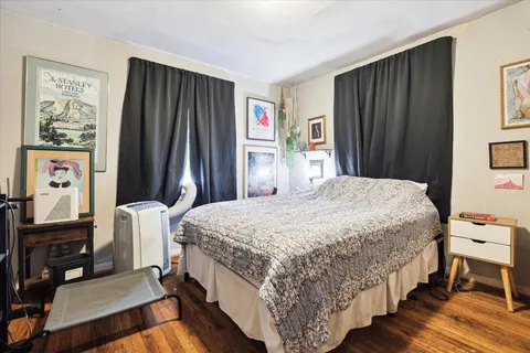 a bedroom with a bed window and a dresser