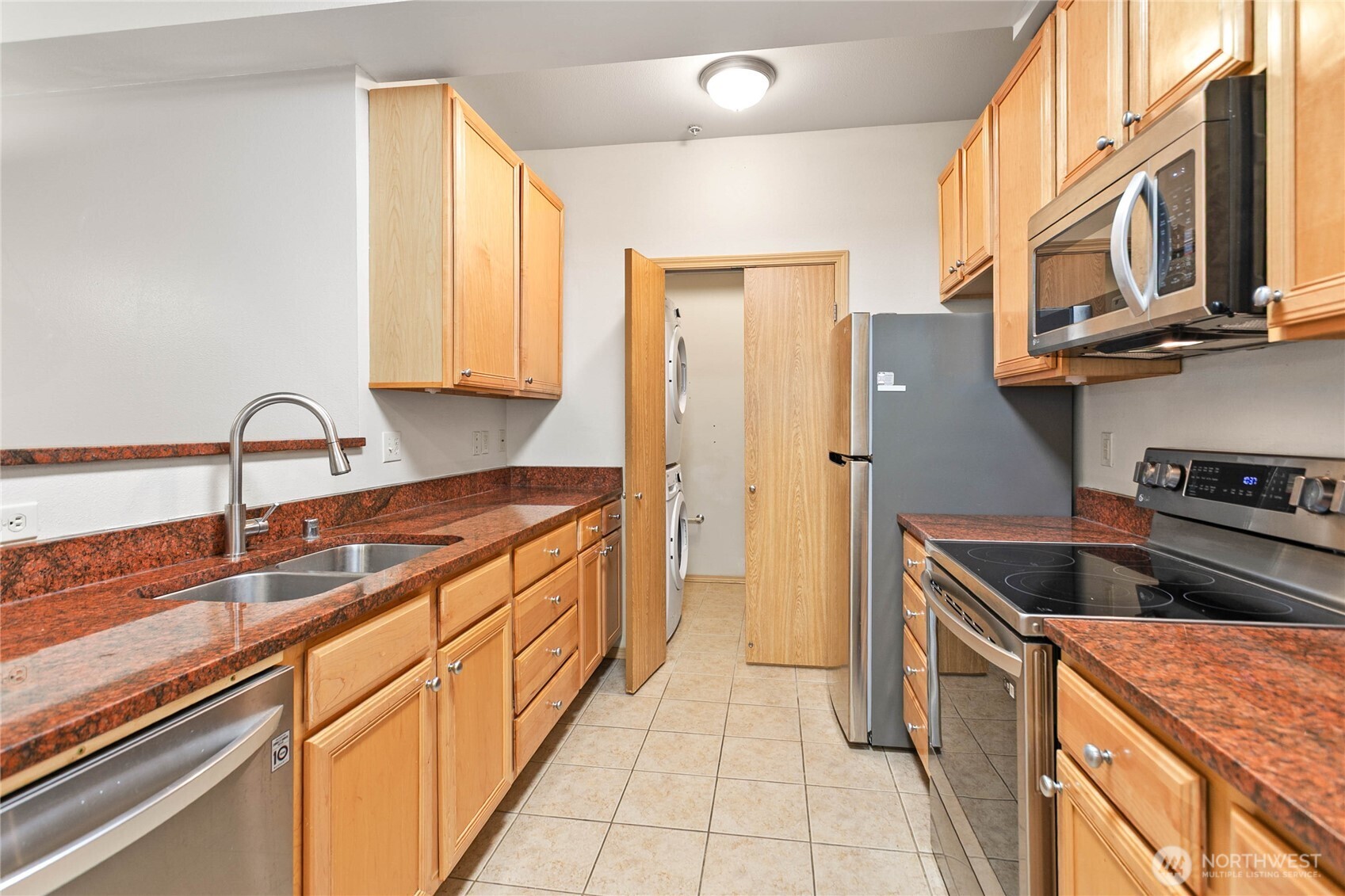 504 Darby Drive, Unit 110 Bellingham, WA 98226 - Photo 14 of 19 a kitchen with stainless steel appliances granite countertop a sink and a refrigerator