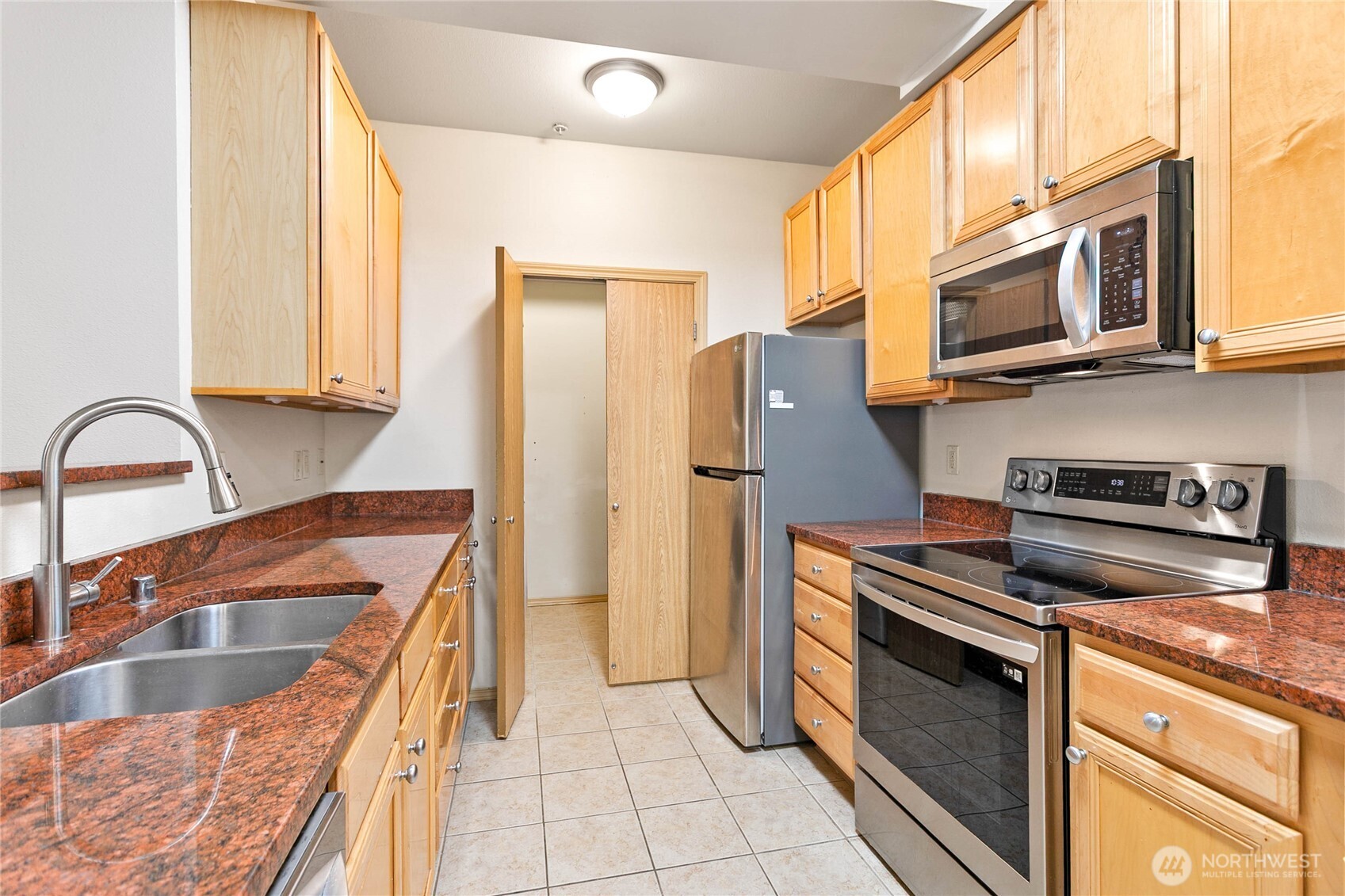 504 Darby Drive, Unit 110 Bellingham, WA 98226 - Photo 15 of 19 a kitchen with stainless steel appliances granite countertop a sink and a refrigerator