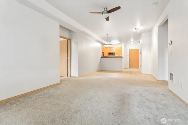 a view of a livingroom with a ceiling fan and window