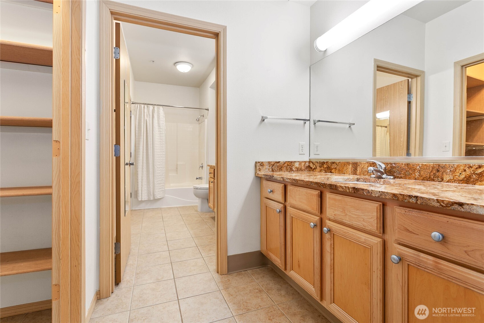 504 Darby Drive, Unit 110 Bellingham, WA 98226 - Photo 7 of 19 a bathroom with a granite countertop sink and a mirror