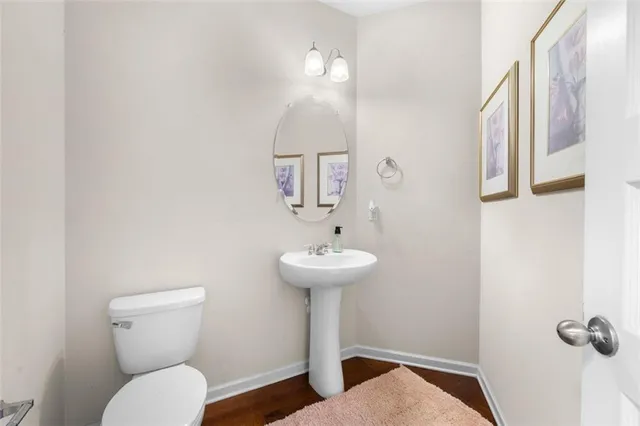 a bathroom with a toilet a sink and mirror