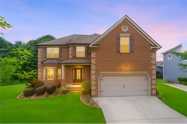a front view of a house with a yard