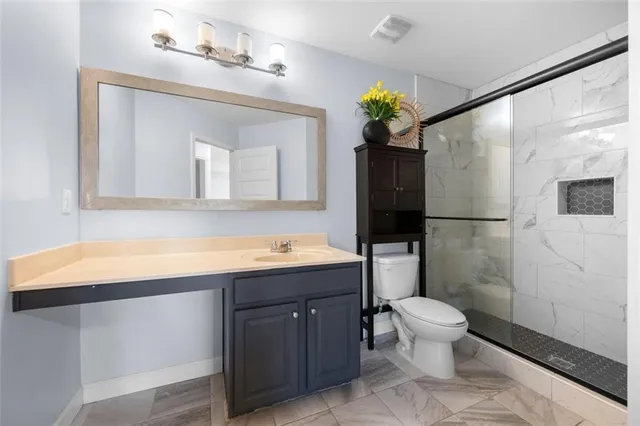 a bathroom with a sink a toilet and a mirror