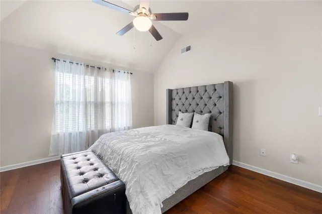 a bedroom with a bed and a chair