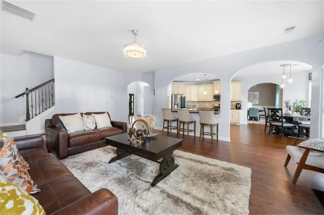a living room with furniture and wooden floor