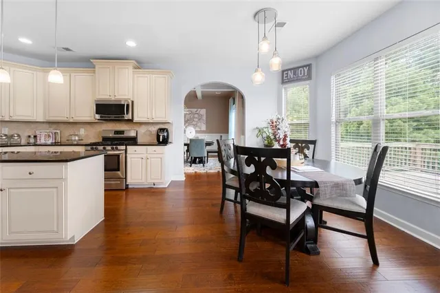 a view of a dining room with furniture window and wooden floor