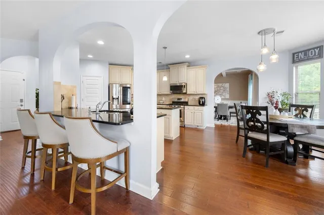 a view of a dining room with furniture and wooden floor