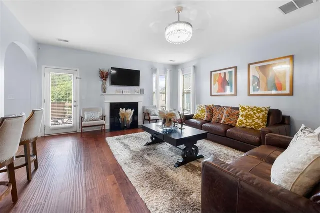 a living room with furniture a flat screen tv and a fireplace