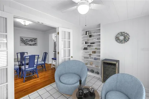 a living room with furniture a lamp and a window
