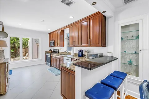 a kitchen with stainless steel appliances granite countertop a stove a sink and a refrigerator