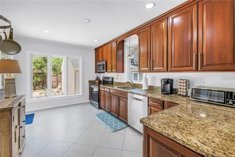a kitchen with stainless steel appliances granite countertop a stove sink and cabinets